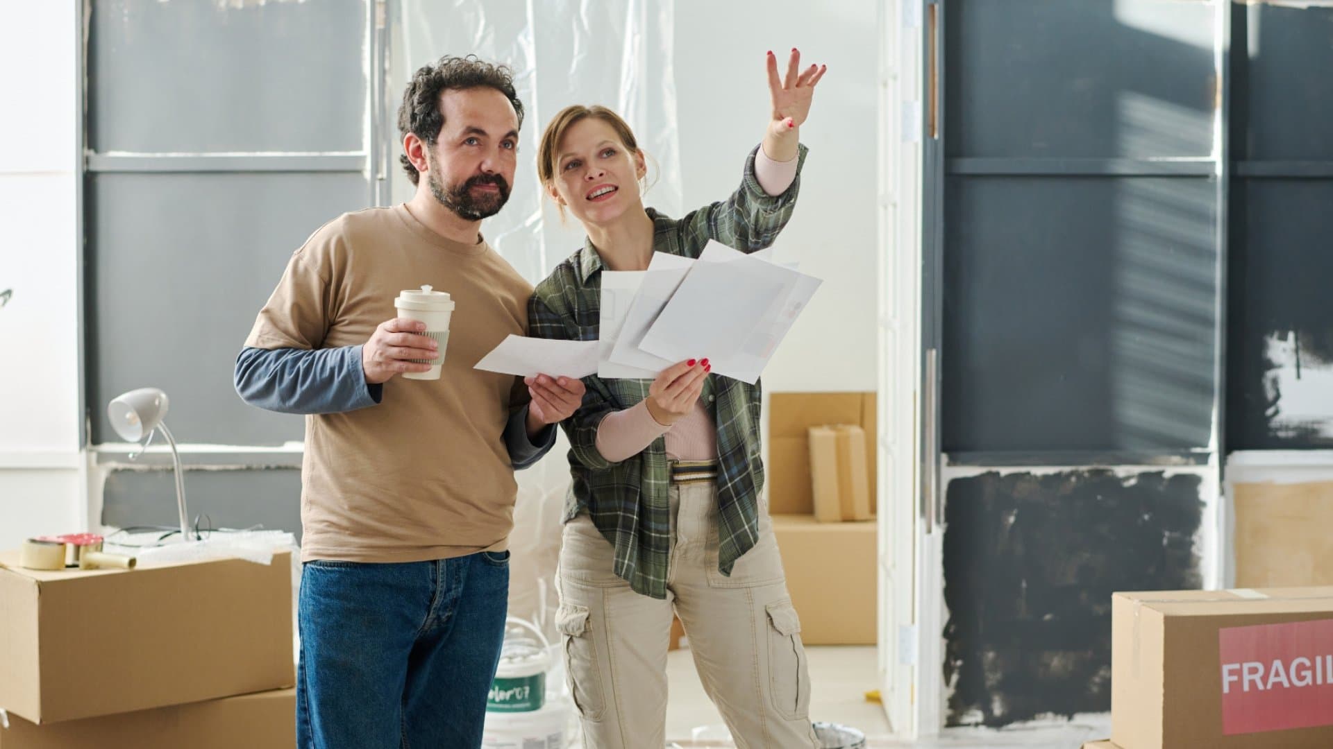 Homeowners reviewing renovation plans with contractor