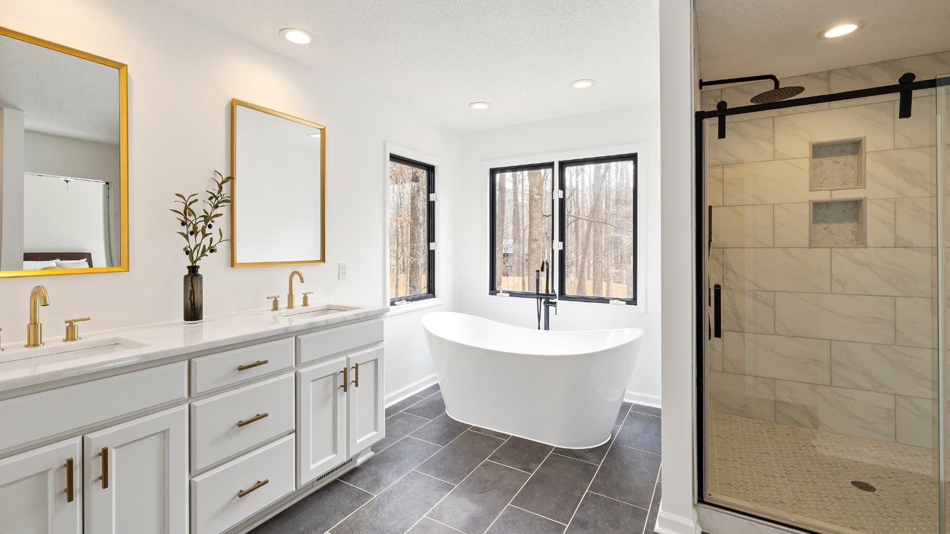 Bathroom remodel with gold fixtures, freestanding tub, and walk-in shower