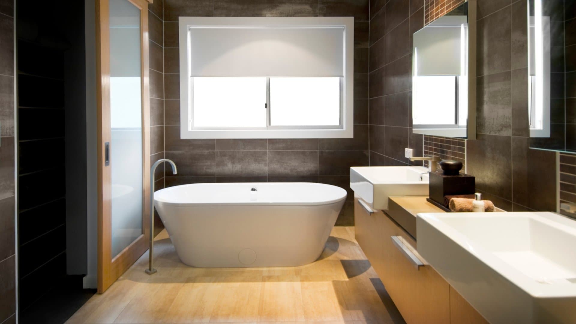 Modern bathroom with dark tile and sleek fixtures