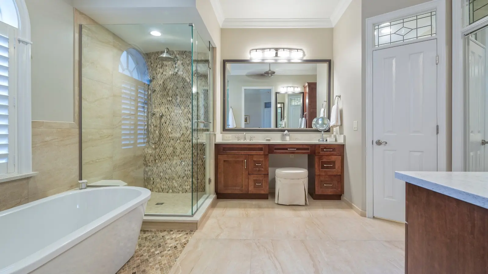 Luxury master bathroom with freestanding tub and glass shower enclosure